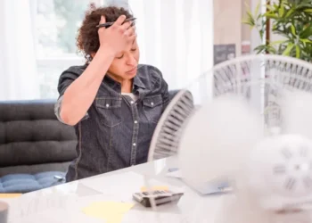 People staying cool during a heatwave by drinking water and avoiding extreme heat