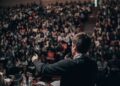 Professional speaker confidently addressing an audience during a public presentation