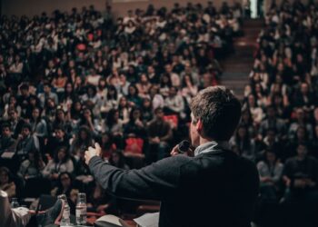 Professional speaker confidently addressing an audience during a public presentation
