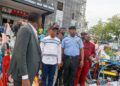 Deputy Governor Joel Salifu assessing fire damage at PEELINKS Electronics in Lokoja