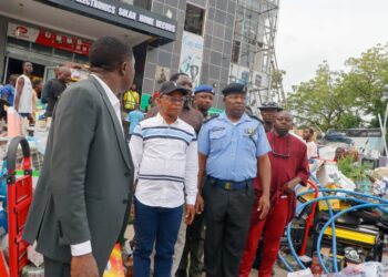 Deputy Governor Joel Salifu assessing fire damage at PEELINKS Electronics in Lokoja